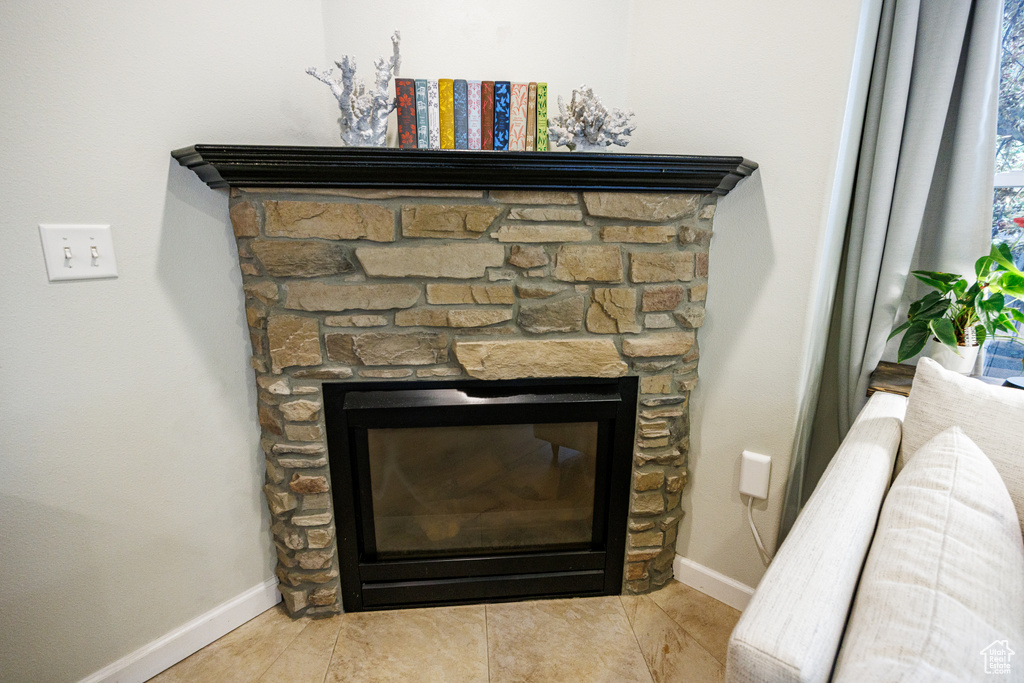 Detailed view of baseboards and a fireplace