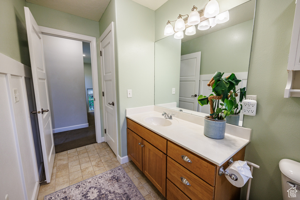 Bathroom with vanity and baseboards
