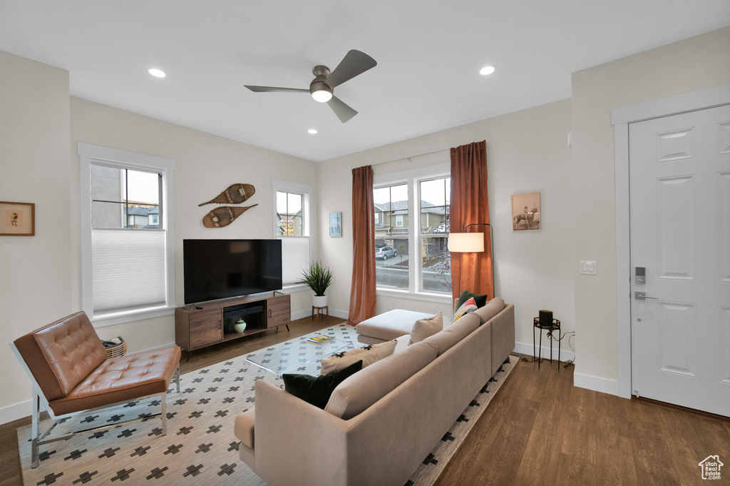 Living room featuring wood finished floors, ceiling fan, baseboards, plenty of natural light, and recessed lighting