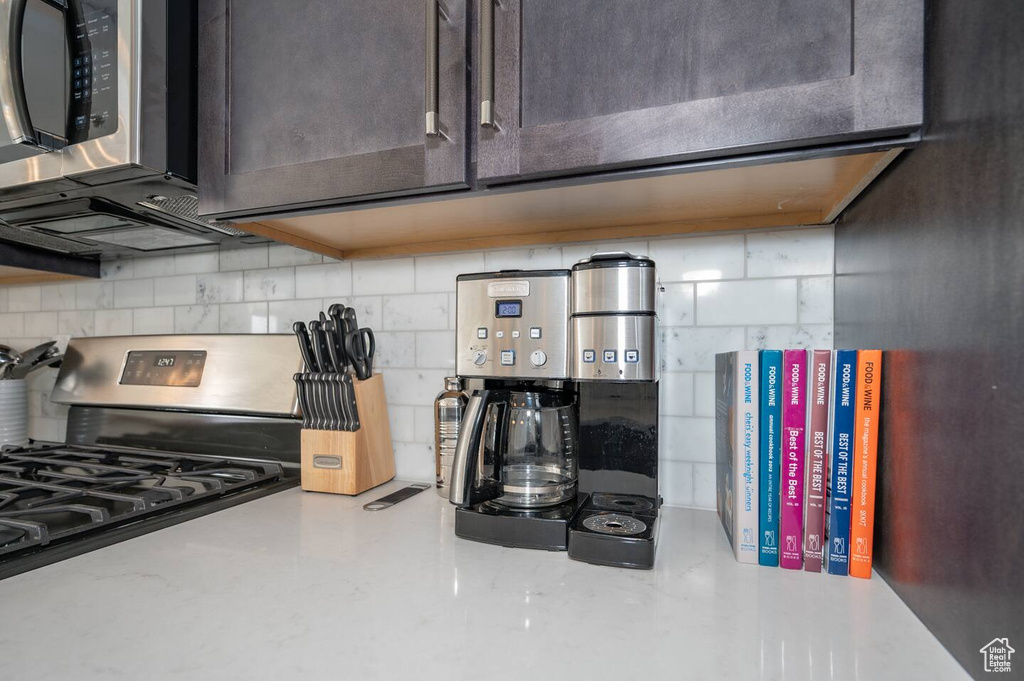 Kitchen with stainless steel appliances and backsplash