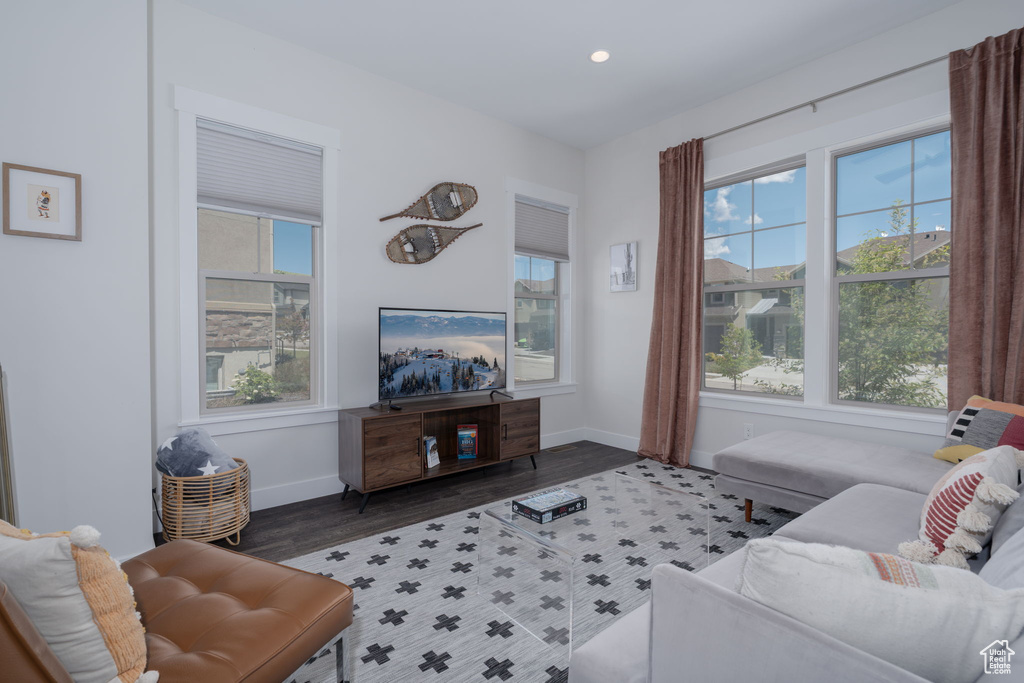 Living room featuring plenty of natural light, baseboards, recessed lighting, and wood finished floors