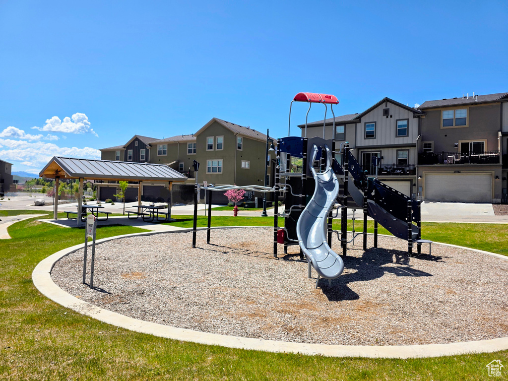 Community play area featuring a residential view, a lawn, and a gazebo