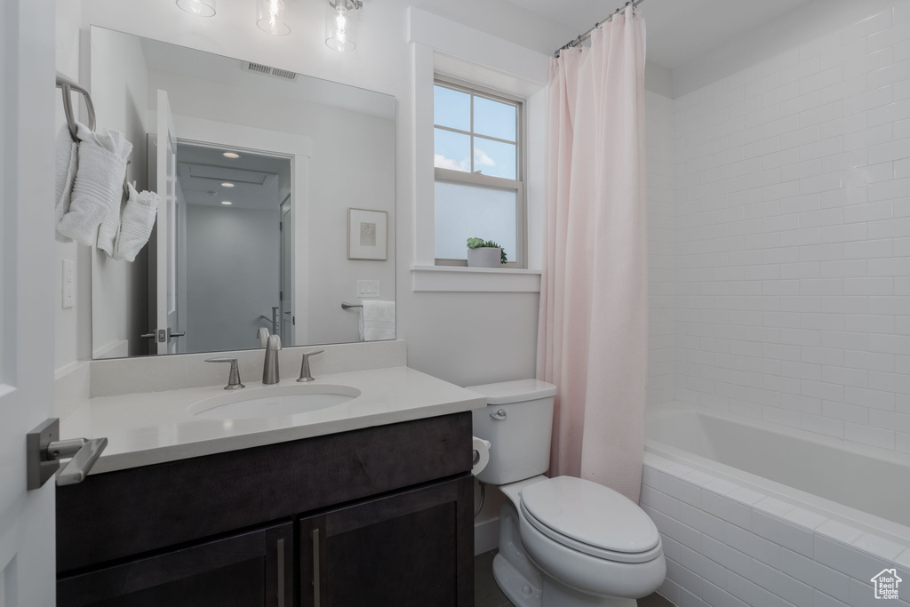 Full bathroom with vanity, toilet, and shower / tub combo