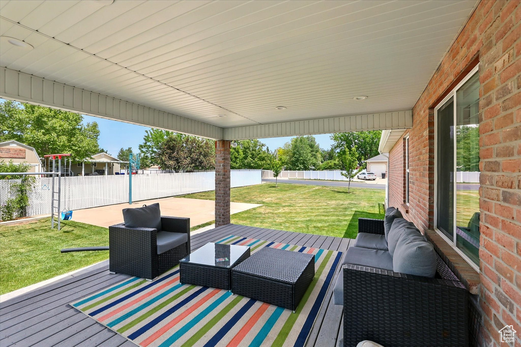 Deck featuring an outdoor living space and a patio
