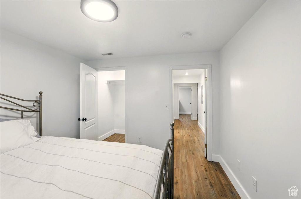 Bedroom featuring wood finished floors and baseboards