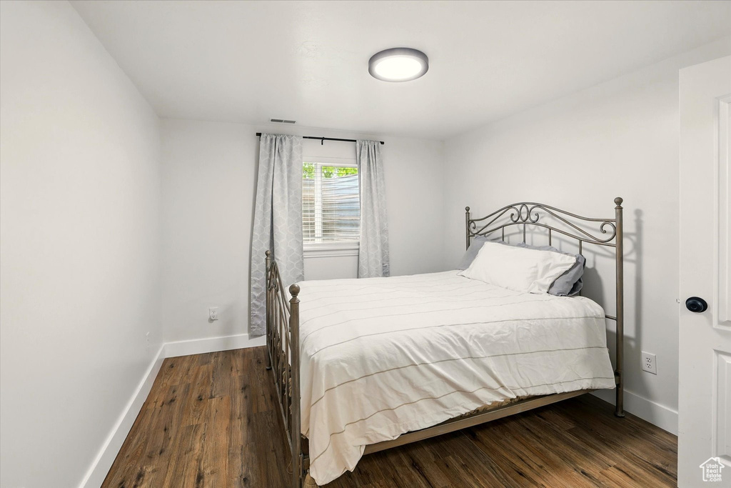 Bedroom with baseboards and wood finished floors