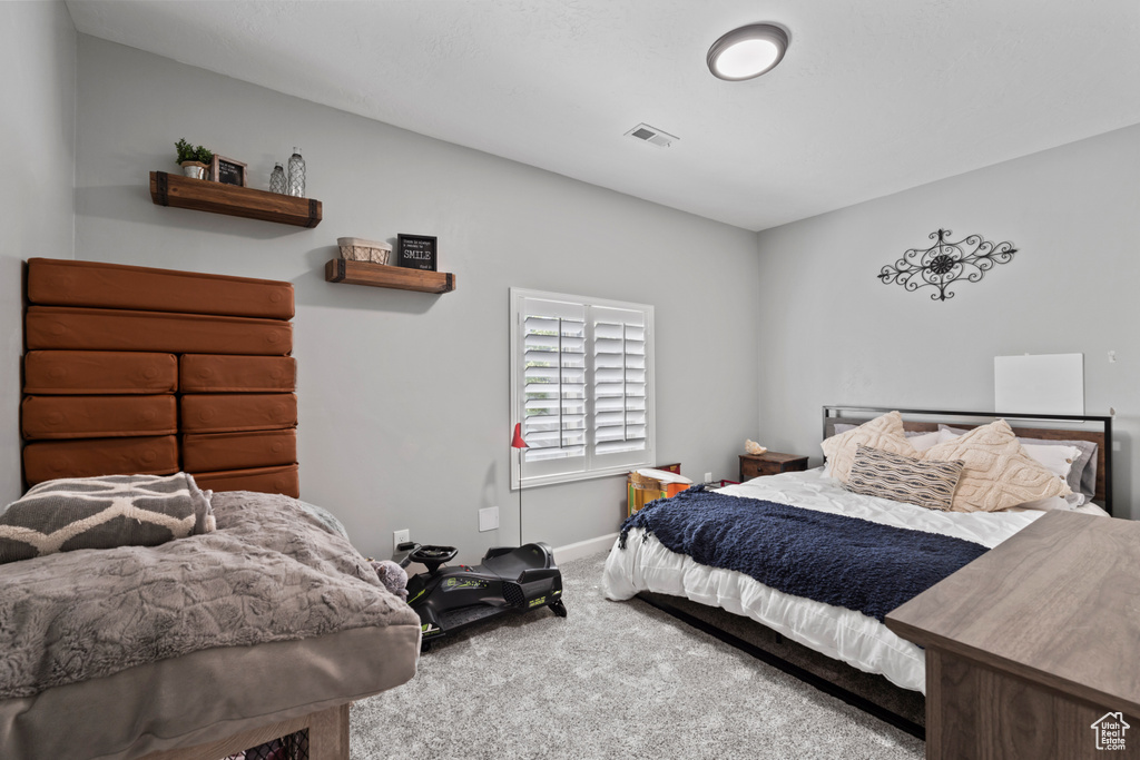 Bedroom featuring carpet floors and baseboards