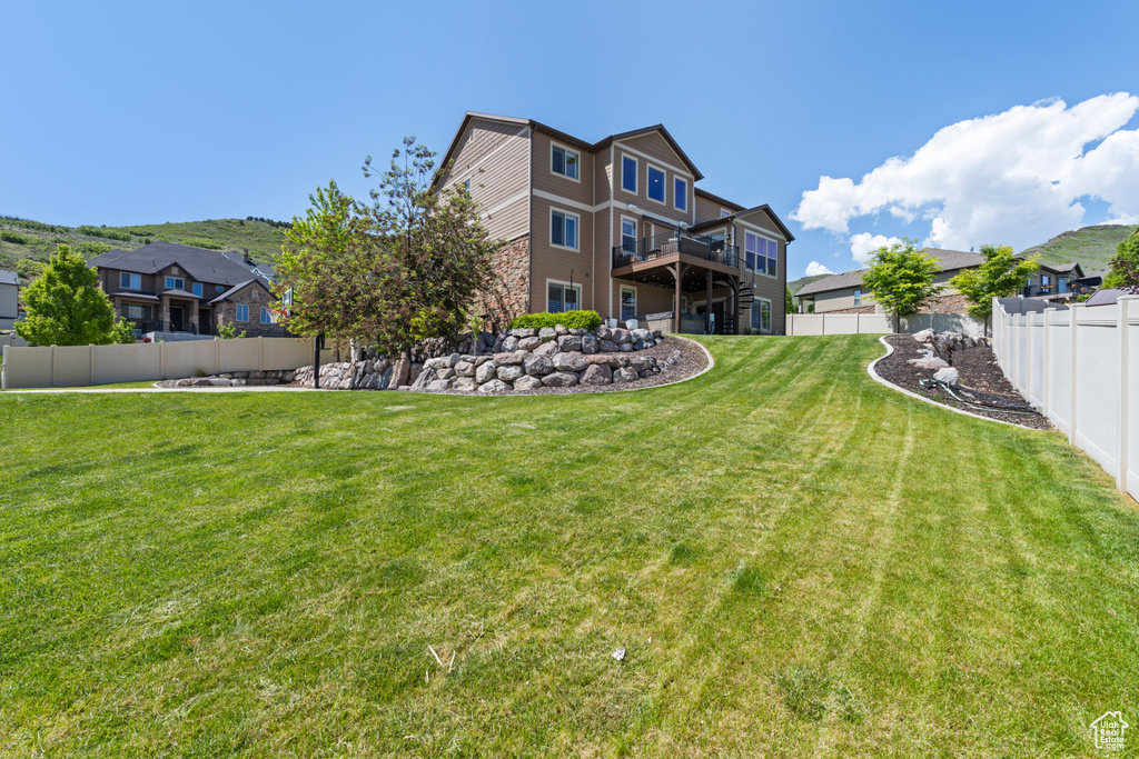 View of yard featuring a residential view and a wooden deck