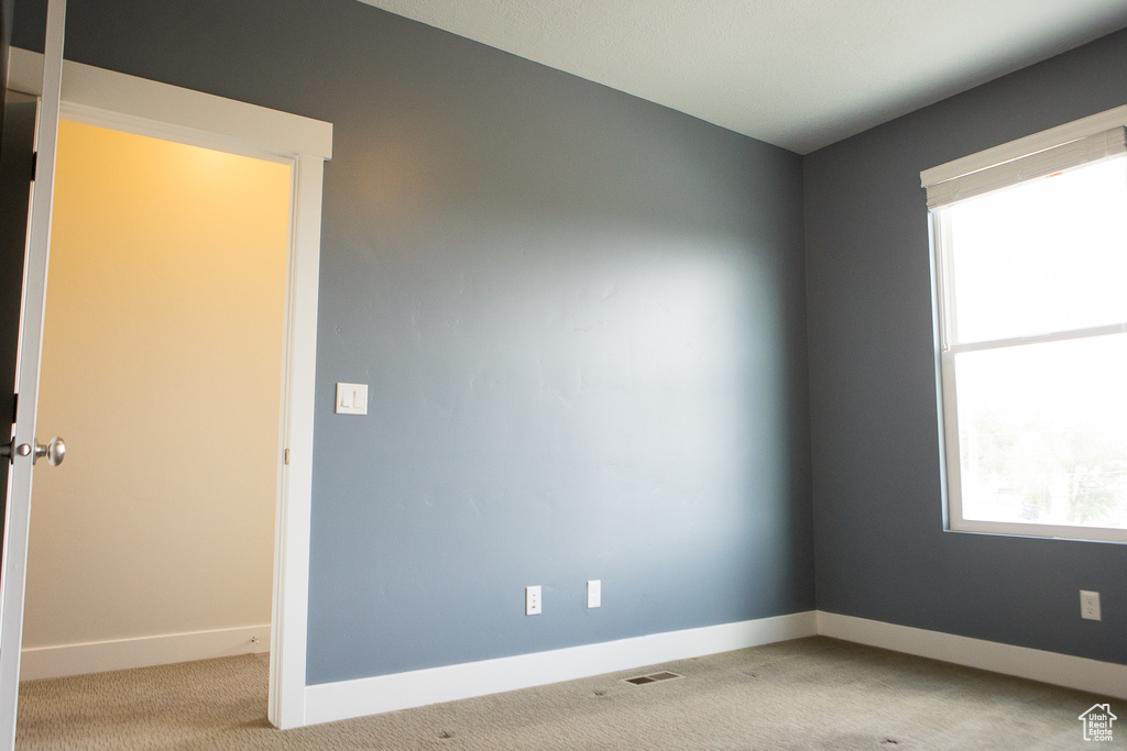 Unfurnished room with carpet floors and baseboards