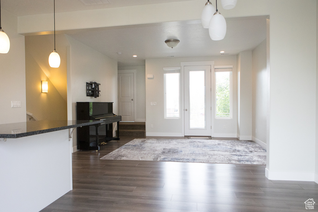 Entrance foyer featuring dark wood-style flooring, baseboards, and recessed lighting
