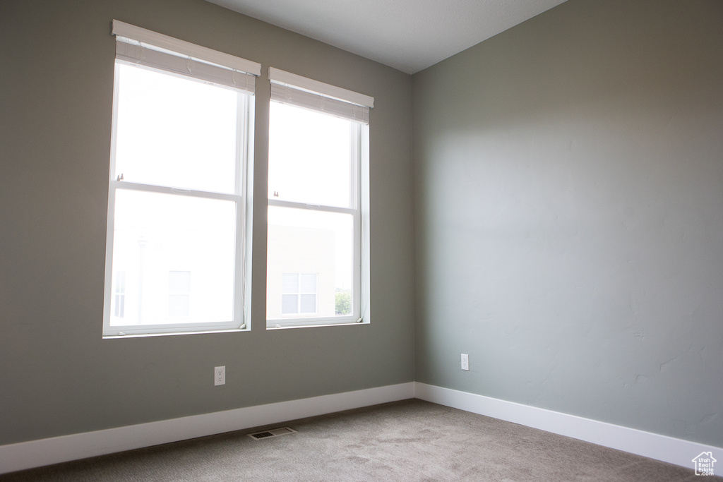 Unfurnished room with carpet flooring and baseboards