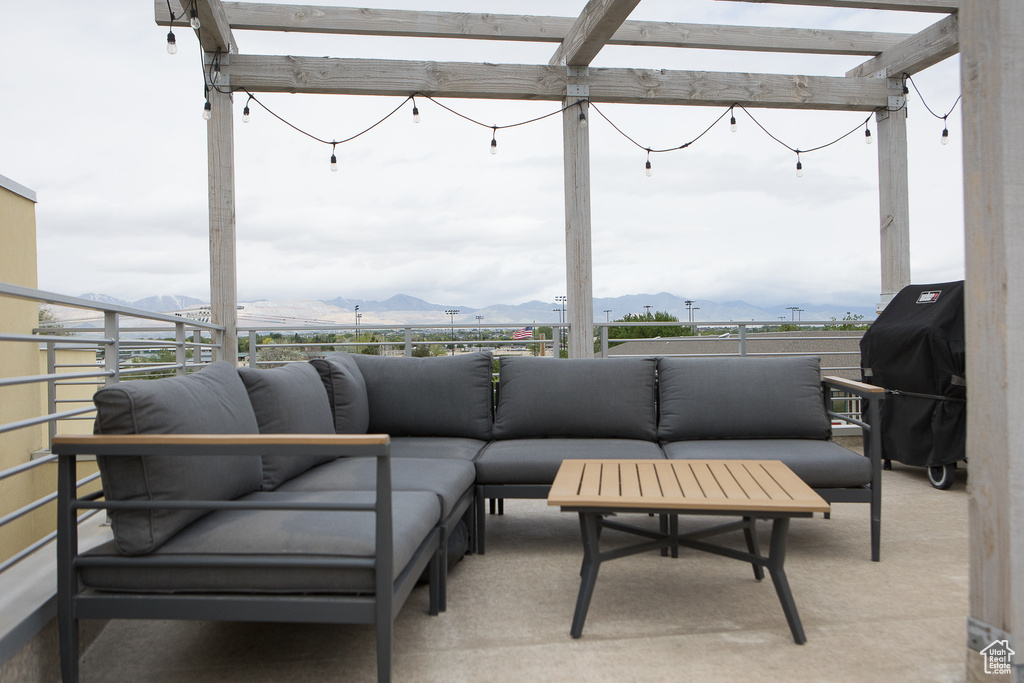 View of patio featuring a mountain view, a grill, and an outdoor living space
