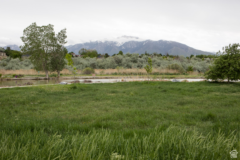 View of mountain backdrop featuring a nearby body of water