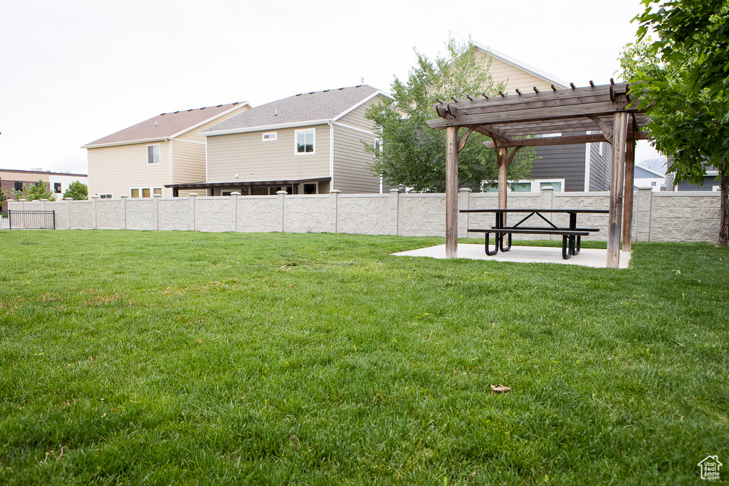 View of yard with a pergola and a patio