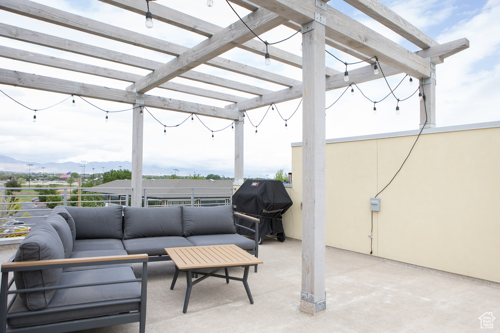 View of patio featuring an outdoor living space, a pergola, a mountain view, and grilling area