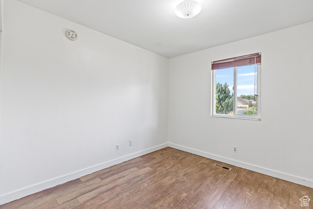 Unfurnished room with baseboards and wood finished floors