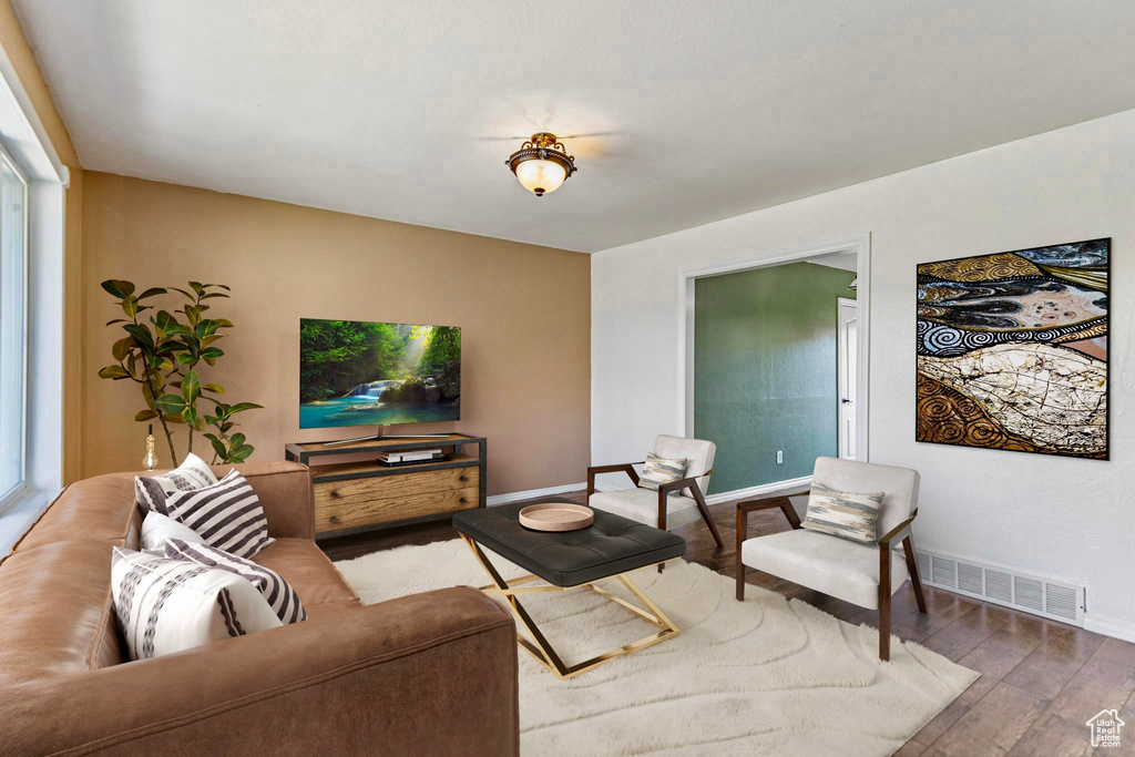 Living area with wood finished floors and baseboards
