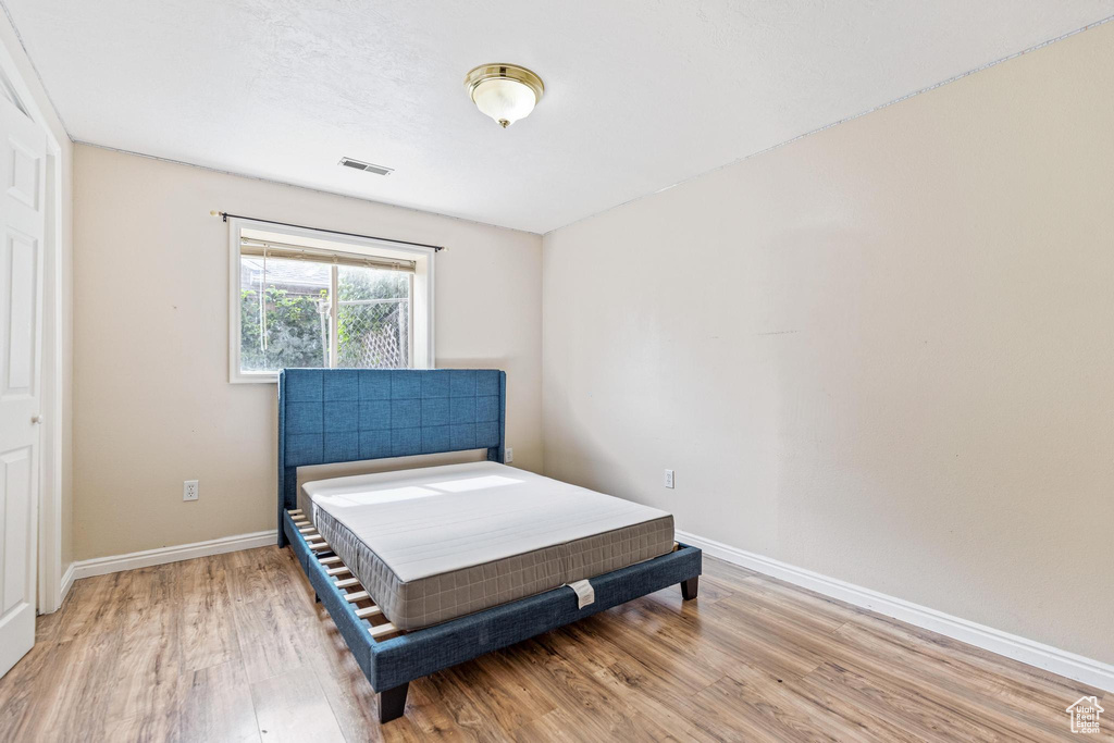 Bedroom featuring light wood-type flooring and baseboards