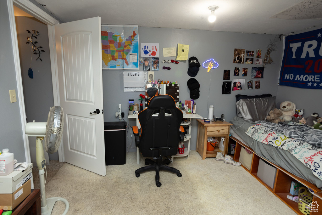 Carpeted bedroom with an office area