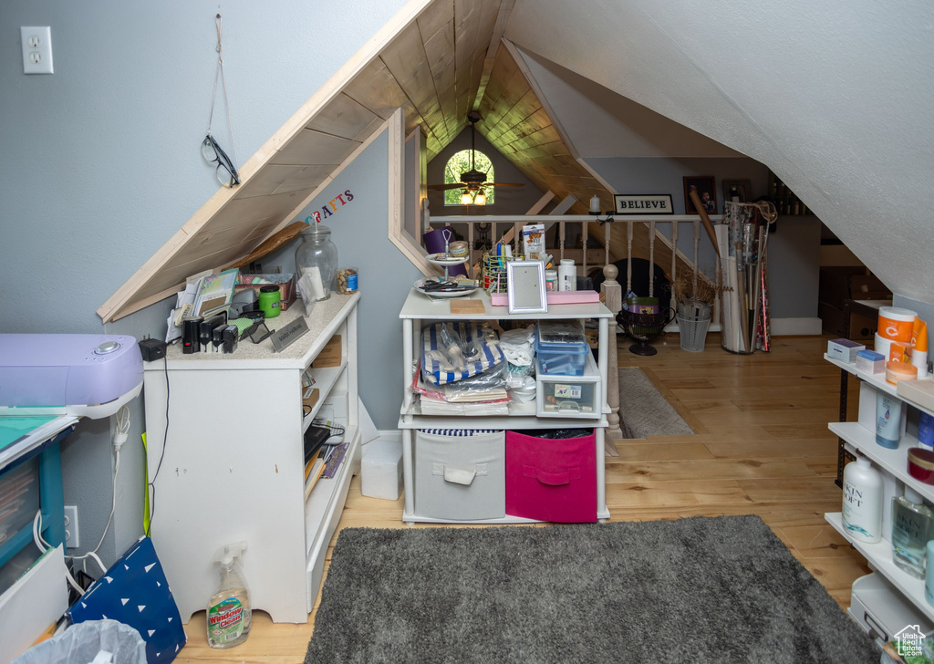 Additional living space with wood finished floors and vaulted ceiling