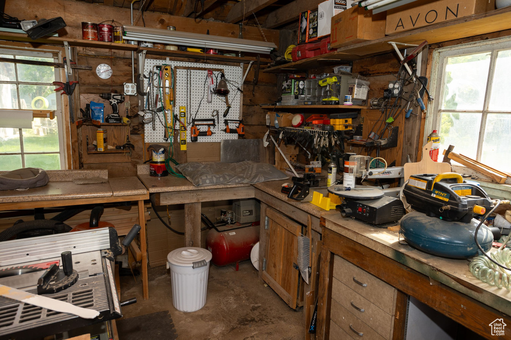 Misc room with a workshop area and unfinished concrete flooring