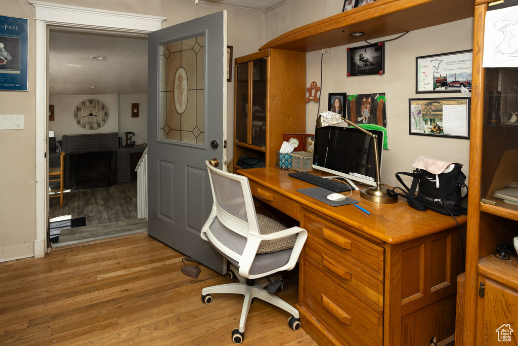 Home office with light wood finished floors