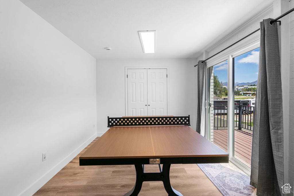 Unfurnished office featuring wood finished floors, baseboards, and a mountain view