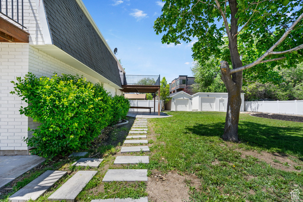 View of yard featuring a balcony