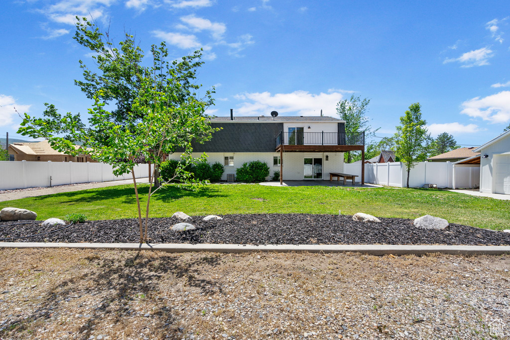 Back of property with a patio and brick siding