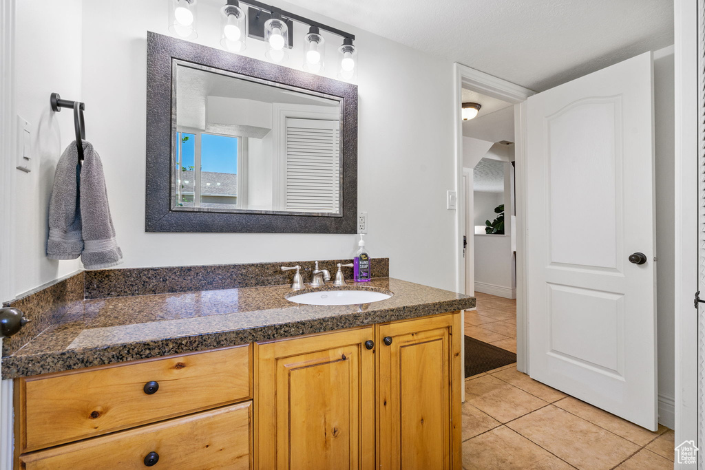 Bathroom featuring vanity and tile patterned floors