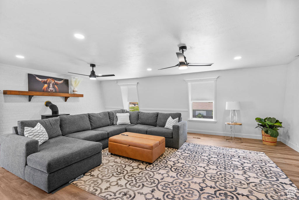Living room featuring ceiling fan, wood finished floors, baseboards, and recessed lighting
