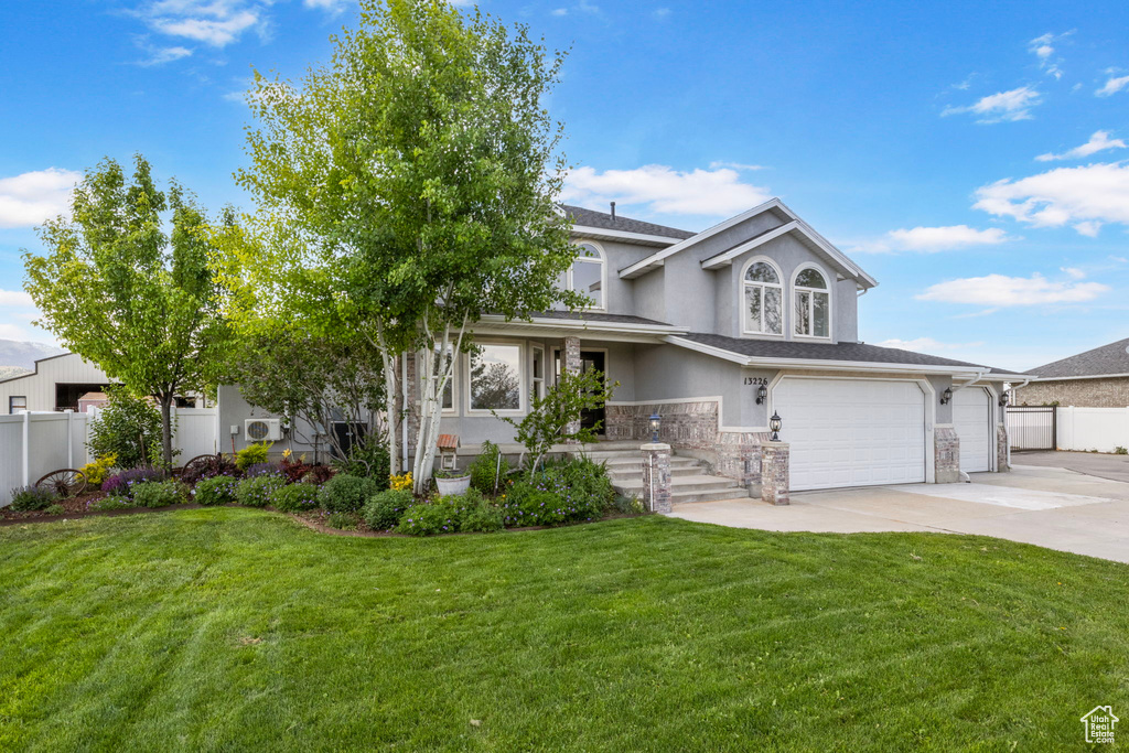 View of front of house featuring stucco siding, concrete driveway, a garage, and stone siding