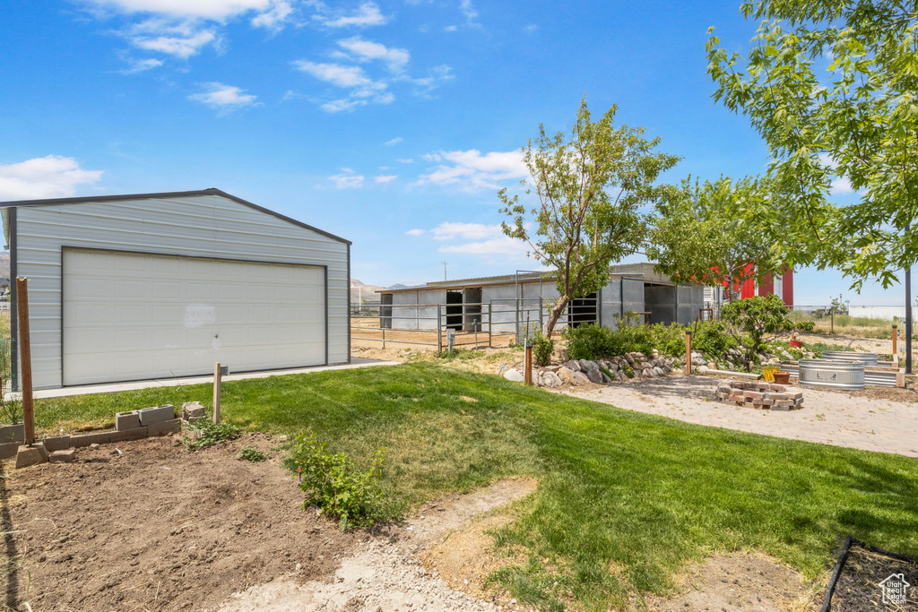 Detached garage featuring a vegetable garden