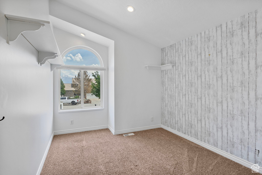 Spare room featuring carpet floors, baseboards, and recessed lighting