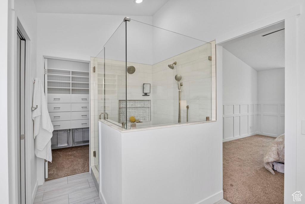Full bathroom with a shower stall, a walk in closet, and recessed lighting