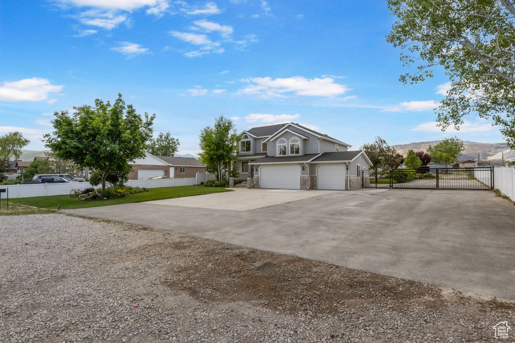 View of front of house featuring concrete driveway, an attached garage, and a mountain view