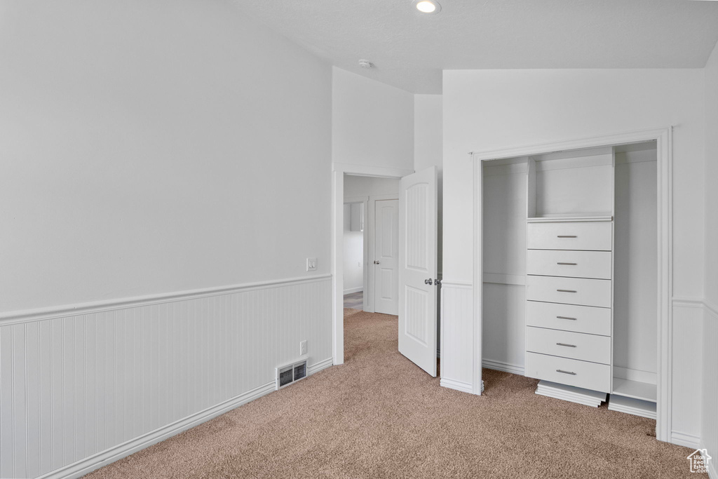 Unfurnished bedroom with carpet floors, a closet, and recessed lighting