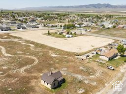 Aerial view of property\'s location featuring a mountainous background