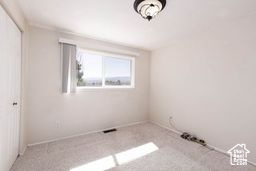 Unfurnished bedroom featuring baseboards and a closet