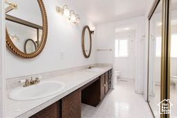 Bathroom with toilet and double vanity