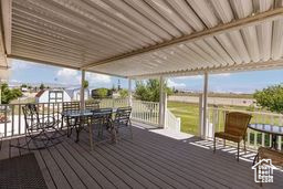 Wooden terrace featuring outdoor dining area
