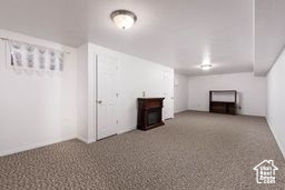 Finished basement featuring a fireplace