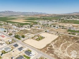 Aerial view of property and surrounding area featuring a mountain backdrop