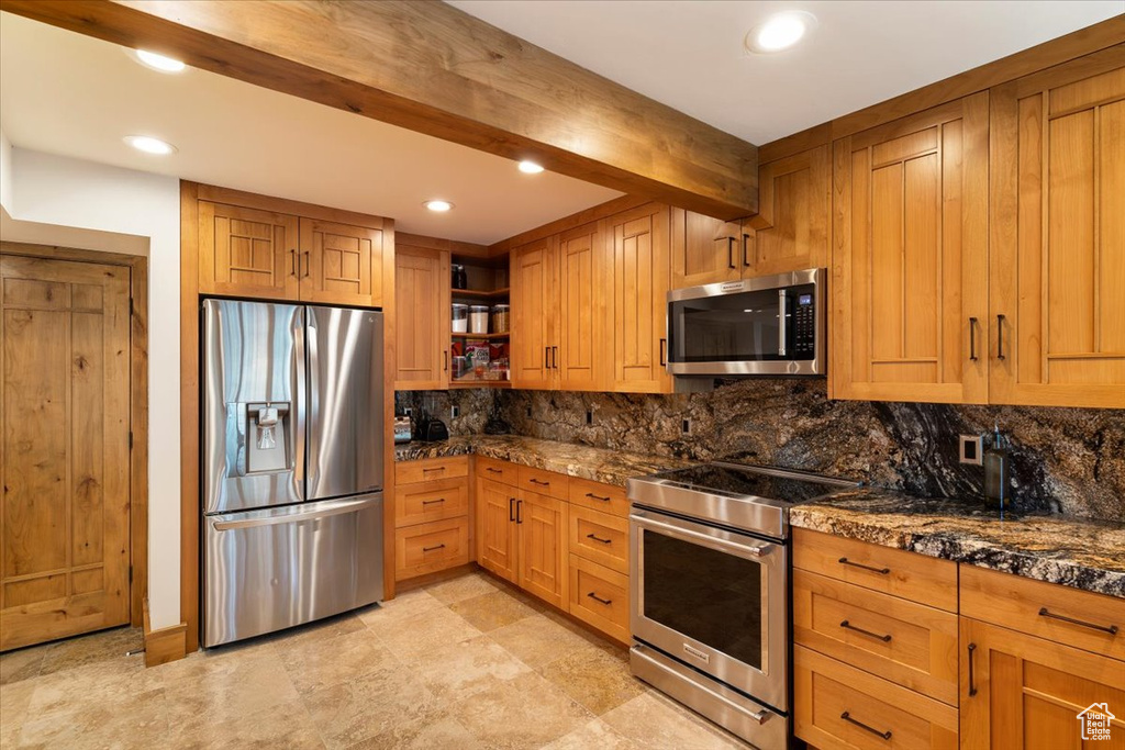 Kitchen with stainless steel appliances, open shelves, backsplash, recessed lighting, and brown cabinetry