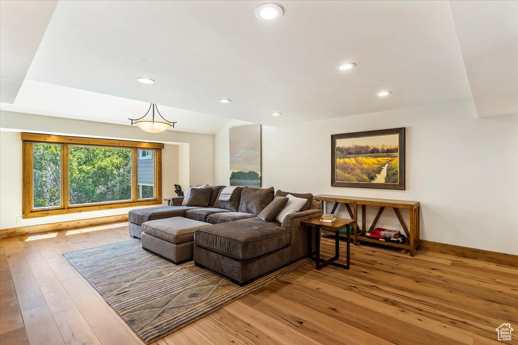 Living room featuring hardwood / wood-style floors, recessed lighting, and baseboards