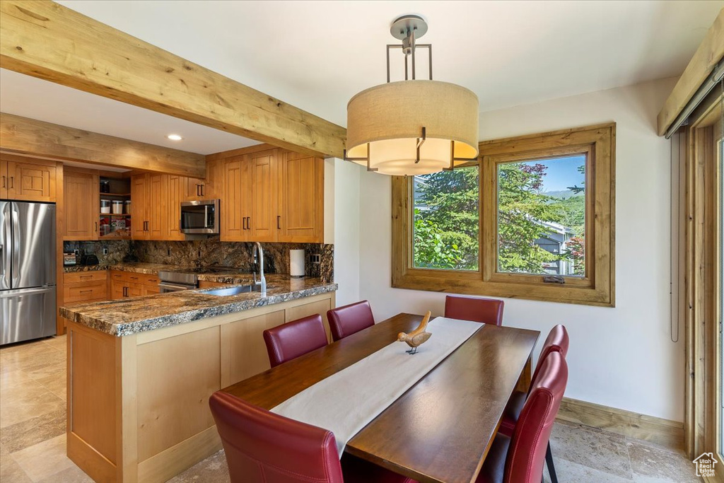 Dining space featuring baseboards, beam ceiling, and recessed lighting
