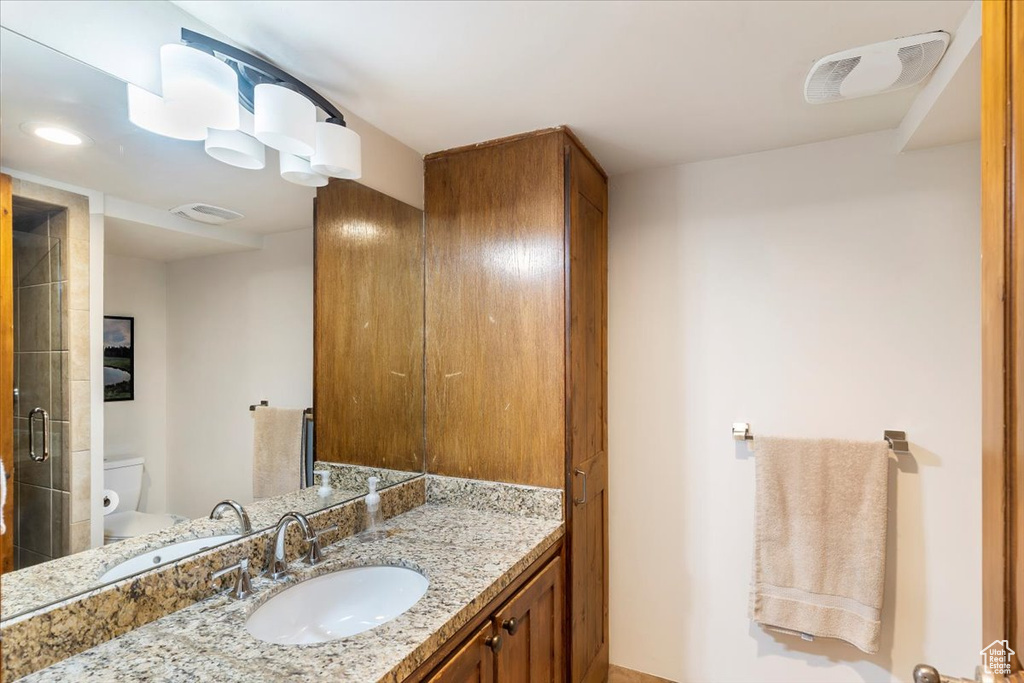 Full bathroom with toilet and vanity