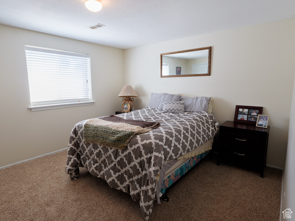 Carpeted bedroom with baseboards