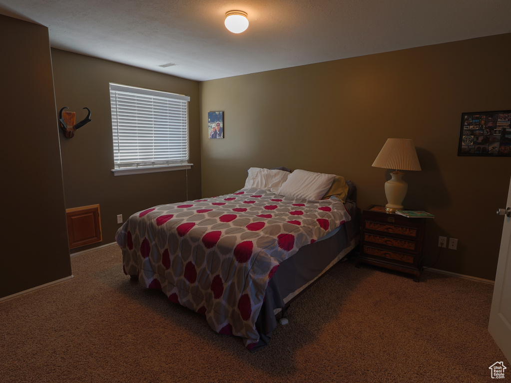 Carpeted bedroom featuring baseboards