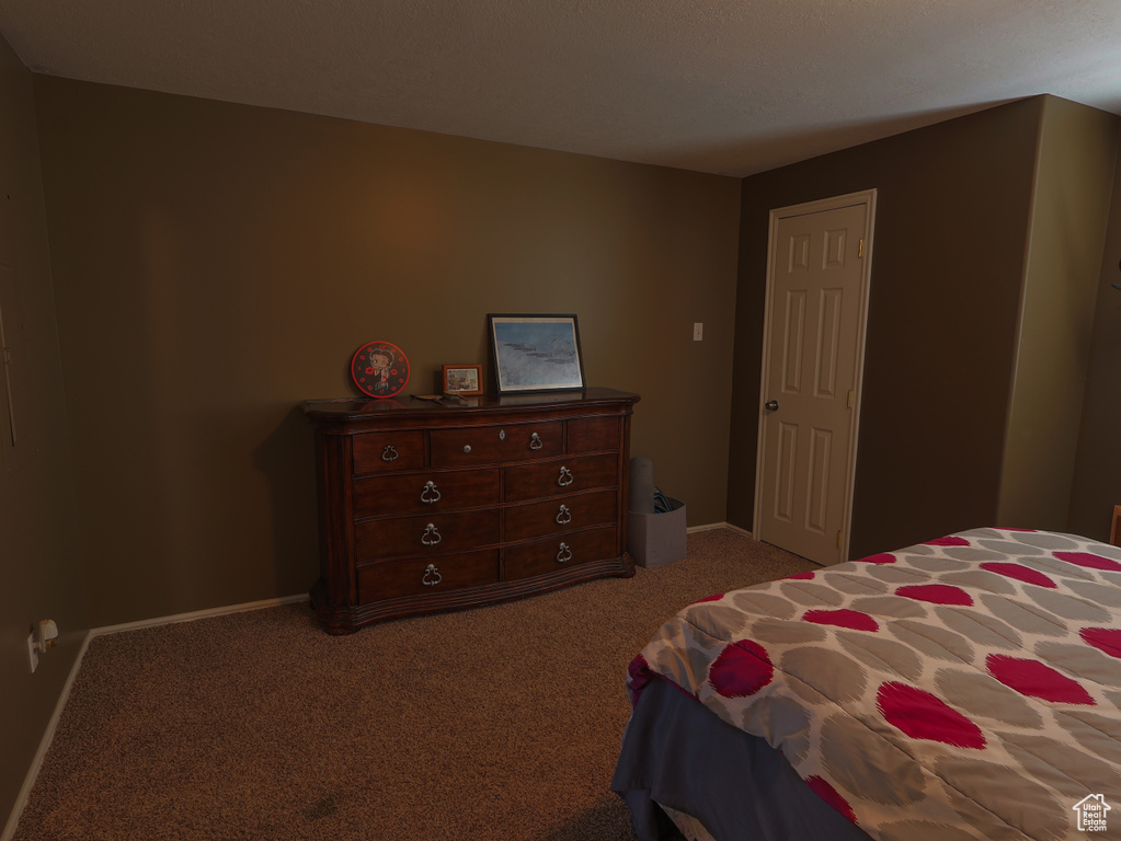 Carpeted bedroom with baseboards